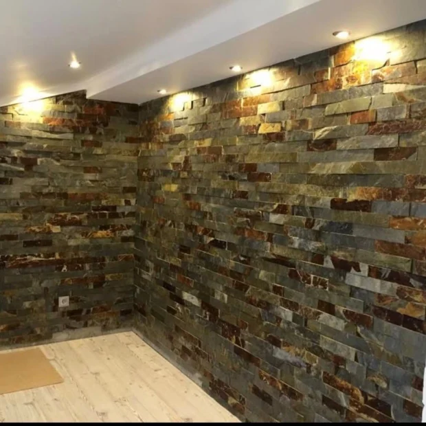 After — the same space with stone-clad walls and recessed lighting
