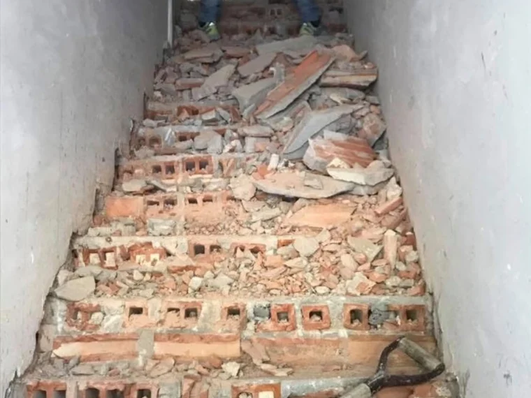 Before — stair stripped back to the masonry