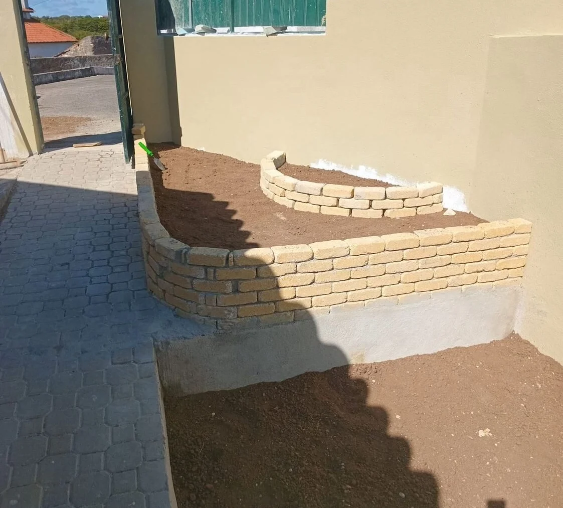 After — stone masonry planters and a cobbled surface