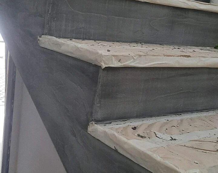 Stair with dark microcement risers and timber treads