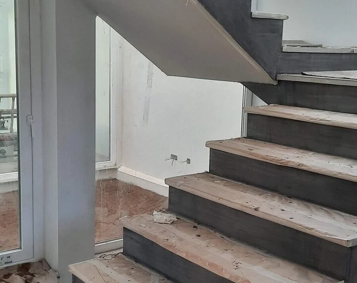 Stair under construction: timber treads on a clad structure