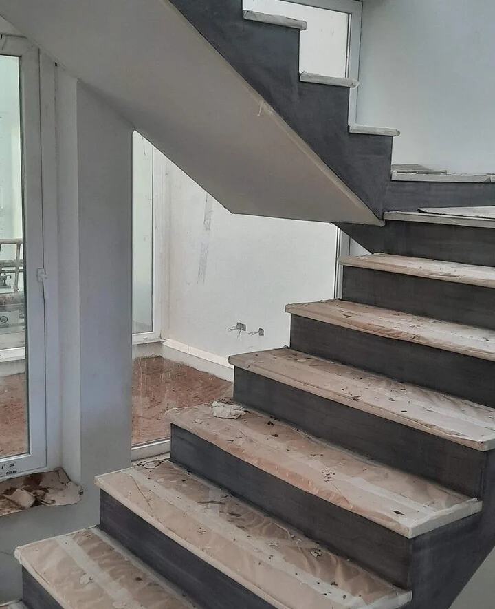 Stair under construction: timber treads on a clad structure
