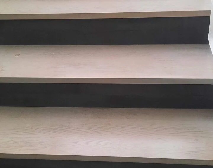 Detail of the pale timber treads over dark microcement