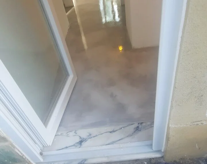 Microcement floor beside a glazed opening