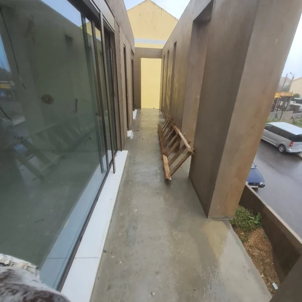 Microcement corridor beside the glazing